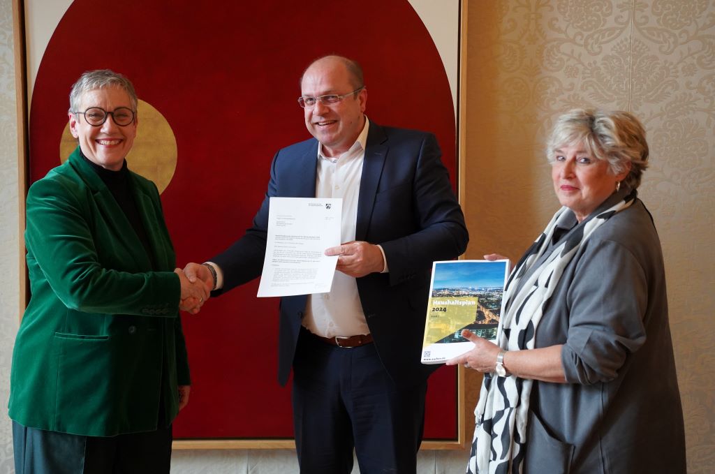 Freigegeben: Oberbürgermeisterin Sibylle Keupen (links) und Stadtkämmerin Annekathrin Grehling bekommen die Haushaltsverfügung von Abteilungsdirektor Daniel Lüngen überreicht. 