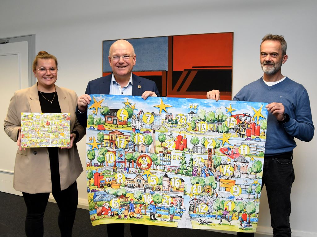 Zusammen mit dem Künstler Ralf Abschlag (r.) und Maria Kettenis von der Repräsentation der Stadt Düren (l.) stellte Bürgermeister Frank Peter Ullrich jetzt das Motiv des diesjährigen Adventskalenders der Stadt Düren vor.